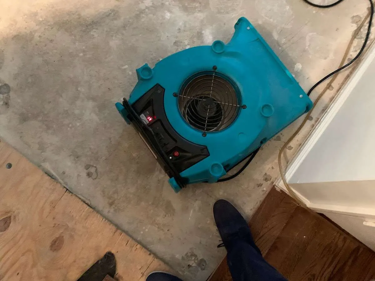 Air mover drying subfloor during Commercial Water Damage Restoration in Rock Springs